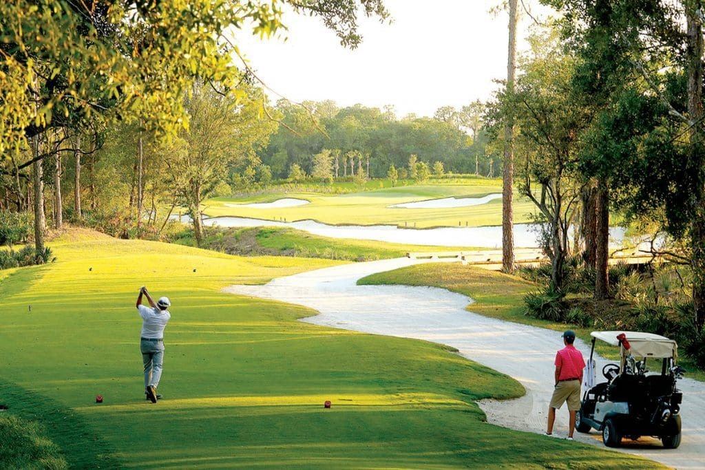 Golfer teeing off on a Lakewood Ranch golf course